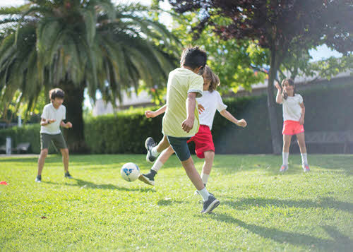chicos pateando una pelota quechua